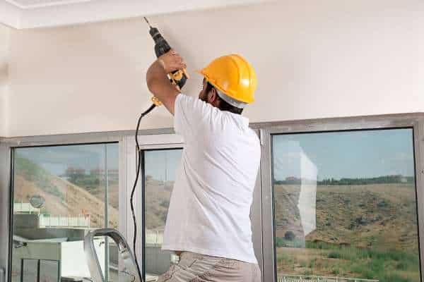 Start by drilling a hole in the ceiling near the outlet box hang string lights in your bedroom